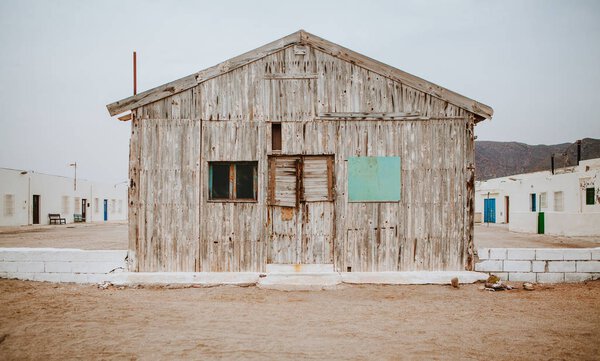 Old wooden cabin, with closed windows and door.