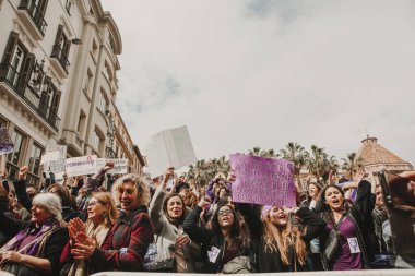 MALAGA, SPAIN - MARCH 8, 2018: Thousands of women take part in the Feminist Strike on the Women Day in the city center of Malaga, Spain, on March 8th 2018. clipart