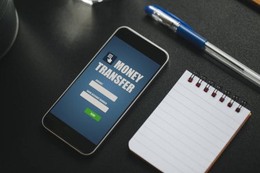Bir cep telefonu ekran siyah iş tablo üzerinde para transferi uygulaması.
