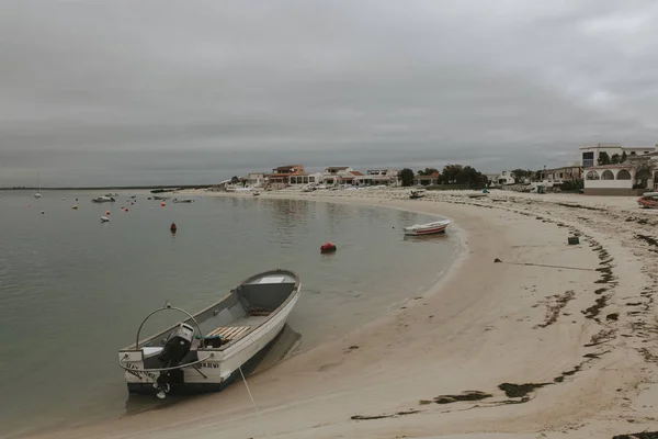 Armona Island, Portugal - March 23, 2018: Little boats docked in the Armona island beach in a cloudy day, at Olhao, Portugal. — Stock Photo, Image