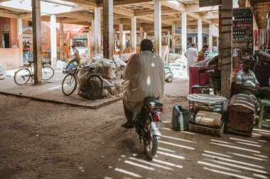 Rissani, Fas - 18 Eylül 2019: Fas 'taki Risanni pazarından motosikletle geçen adam.