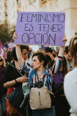MALAGA, SPAIN - MARCH 8 th, 2020: Woman showing feminist banner during feminist strike in Malaga, Spain, on March 8 th, 2020.