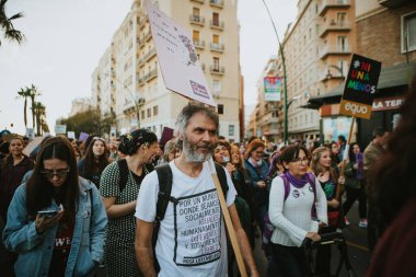 MALAGA, SPAIN - MARCH 8 th, 2020: Man showing feminist banner during feminist strike in Malaga, Spain, on March 8 th, 2020.
