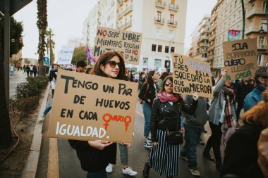 MALAGA, SPAIN - MARCH 8 th, 2020: Woman showing feminist banners during feminist strike in Malaga, Spain, on March 8 th, 2020.