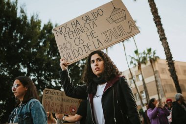MALAGA, SPAIN - MARCH 8 th, 2020: Woman showing feminist banners during feminist strike in Malaga, Spain, on March 8 th, 2020.