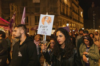 MALAGA, SPAIN - MARCH 8 th, 2020: People showing feminist banners and protest placards during feminist strike in Malaga, Spain, on March 8 th, 2020.