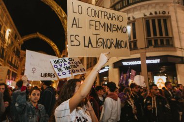 MALAGA, SPAIN - MARCH 8 th, 2020: People showing feminist banners and protest placards during feminist strike in Malaga, Spain, on March 8 th, 2020.