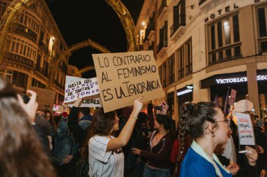 MALAGA, SPAIN - MARCH 8 th, 2020: People showing feminist banners and protest placards during feminist strike in Malaga, Spain, on March 8 th, 2020.
