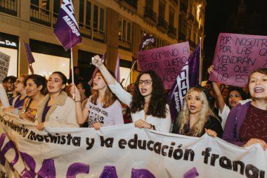 MALAGA, SPAIN - MARCH 8 th, 2020: People celebrating 8m woman day with banners and placards, during feminist strike in Malaga, Spain, on March 8 th, 2020.