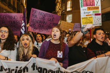 MALAGA, SPAIN - MARCH 8 th, 2020: People celebrating 8m woman day with banners and placards, during feminist strike in Malaga, Spain, on March 8 th, 2020.