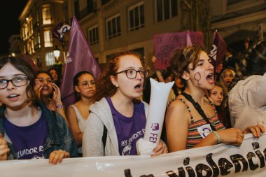 MALAGA, SPAIN - MARCH 8 th, 2020: People celebrating 8m woman day with banners and placards, during feminist strike in Malaga, Spain, on March 8 th, 2020.