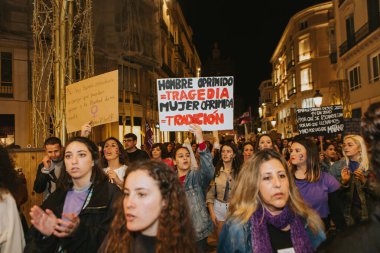 MALAGA, SPAIN - MARCH 8 th, 2020: People celebrating 8m woman day with banners and placards, during feminist strike in Malaga, Spain, on March 8 th, 2020.