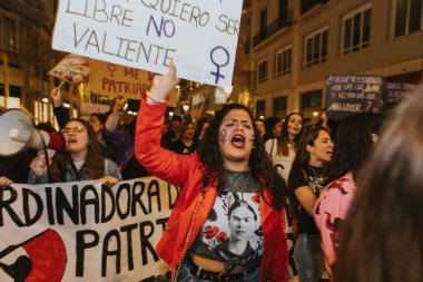 MALAGA, SPAIN - MARCH 8 th, 2020: People celebrating 8m woman day with banners and placards, during feminist strike in Malaga, Spain, on March 8 th, 2020.