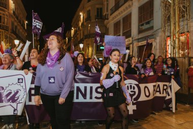 MALAGA, SPAIN - MARCH 8 th, 2020: People celebrating 8m woman day with banners and placards, during feminist strike in Malaga, Spain, on March 8 th, 2020.