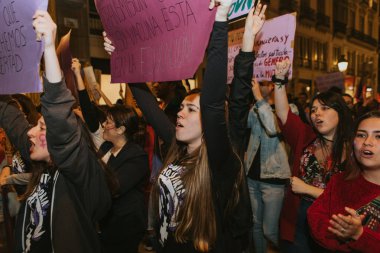 MALAGA, SPAIN - MARCH 8 th, 2020: People celebrating 8m woman day with banners and placards, during feminist strike in Malaga, Spain, on March 8 th, 2020.