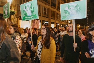 MALAGA, SPAIN - MARCH 8 th, 2020: People celebrating 8m woman day with banners and placards, during feminist strike in Malaga, Spain, on March 8 th, 2020.