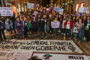 MALAGA, SPAIN - MARCH 8 th, 2020: People celebrating 8m woman day with banners and placards, during feminist strike in Malaga, Spain, on March 8 th, 2020.