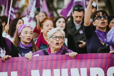 MALAGA, SPAIN - MARCH 8 th, 2020: People celebrating 8m woman day with banners and placards, during feminist strike in Malaga, Spain, on March 8 th, 2020.