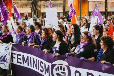 MALAGA, SPAIN - MARCH 8 th, 2020: People celebrating 8m woman day with banners and placards, during feminist strike in Malaga, Spain, on March 8 th, 2020.