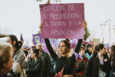 MALAGA, SPAIN - MARCH 8 th, 2020: People celebrating 8m woman day with banners and placards, during feminist strike in Malaga, Spain, on March 8 th, 2020.