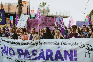 MALAGA, SPAIN - MARCH 8 th, 2020: People celebrating 8m woman day with banners and placards, during feminist strike in Malaga, Spain, on March 8 th, 2020.