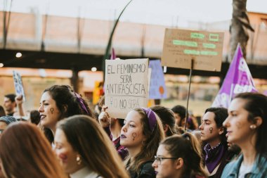 MALAGA, SPAIN - MARCH 8 th, 2020: People celebrating 8m woman day with banners and placards, during feminist strike in Malaga, Spain, on March 8 th, 2020.