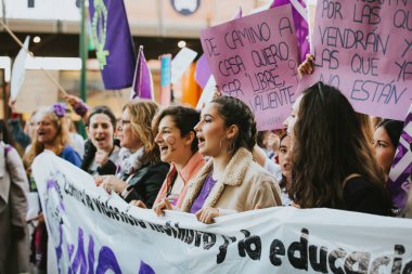 MALAGA, SPAIN - MARCH 8 th, 2020: People celebrating 8m woman day with banners and placards, during feminist strike in Malaga, Spain, on March 8 th, 2020.