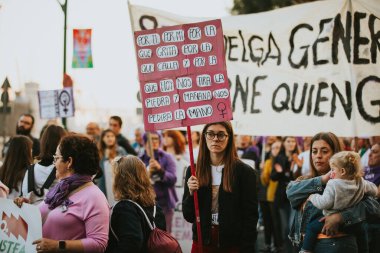MALAGA, SPAIN - MARCH 8 th, 2020: People celebrating 8m woman day with banners and placards, during feminist strike in Malaga, Spain, on March 8 th, 2020.