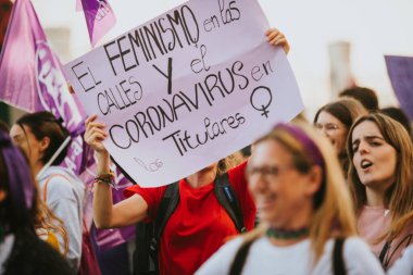 MALAGA, SPAIN - MARCH 8 th, 2020: People celebrating 8m woman day with banners and placards, during feminist strike in Malaga, Spain, on March 8 th, 2020.