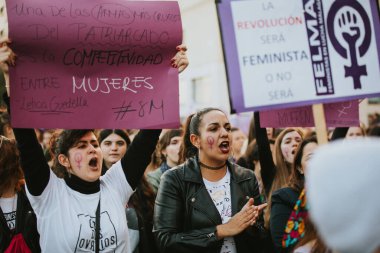 MALAGA, SPAIN - MARCH 8 th, 2020: People celebrating 8m woman day with banners and placards, during feminist strike in Malaga, Spain, on March 8 th, 2020.