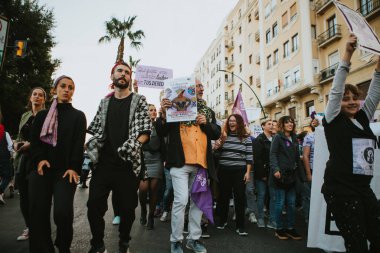MALAGA, SPAIN - MARCH 8 th, 2020: People celebrating 8m woman day with banners and placards, during feminist strike in Malaga, Spain, on March 8 th, 2020.