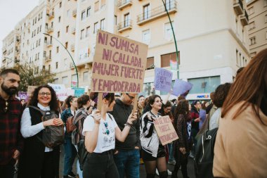MALAGA, SPAIN - MARCH 8 th, 2020: People celebrating 8m woman day with banners and placards, during feminist strike in Malaga, Spain, on March 8 th, 2020.