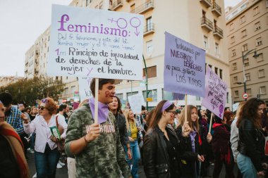 MALAGA, SPAIN - MARCH 8 th, 2020: People celebrating 8m woman day with banners and placards, during feminist strike in Malaga, Spain, on March 8 th, 2020.