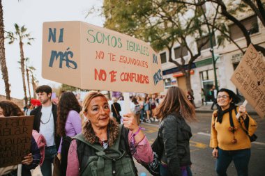 MALAGA, SPAIN - MARCH 8 th, 2020: People celebrating 8m woman day with banners and placards, during feminist strike in Malaga, Spain, on March 8 th, 2020.