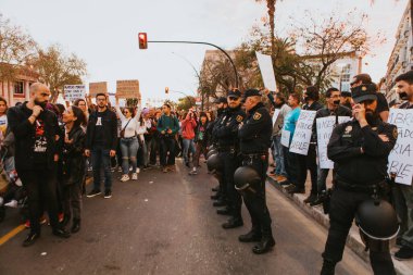 MALAGA, SPAIN - MARCH 8 th, 2020: People celebrating 8m woman day with banners and placards, during feminist strike in Malaga, Spain, on March 8 th, 2020.