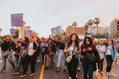 MALAGA, SPAIN - MARCH 8 th, 2020: People celebrating 8m woman day with banners and placards, during feminist strike in Malaga, Spain, on March 8 th, 2020.