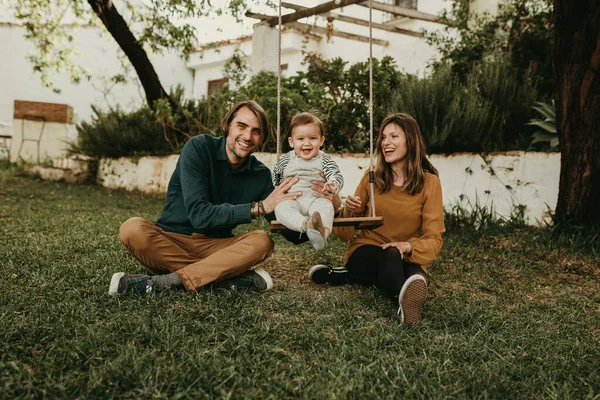 Vader Moeder Zwaaien Met Hun Baby Zittend Het Groene Gras — Stockfoto