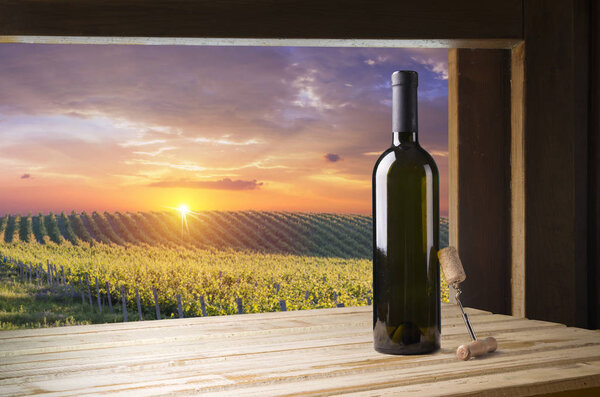 Red wine with barrel on vineyard in green Tuscany, Italy