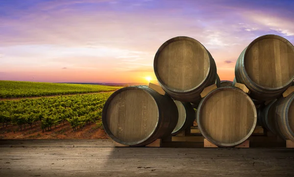 Red wine with barrel on vineyard in green Tuscany, Italy