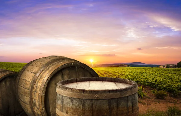 Red wine with barrel on vineyard in green Tuscany, Italy