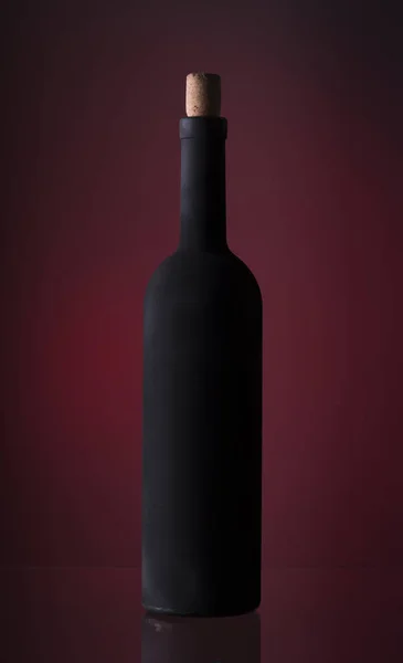 Pouring red wine into the glass against wooden background — Stock Photo, Image