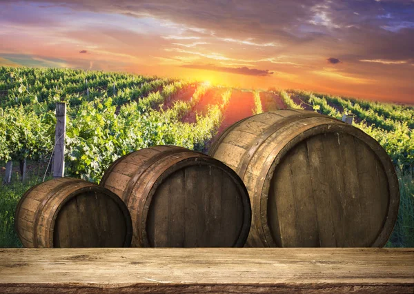 Red wine with barrel on vineyard in green Tuscany, Italy