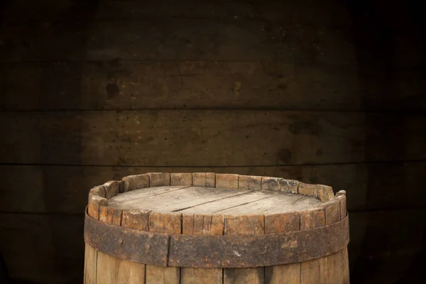 Old wooden barrel on a brown background — Stock Photo, Image