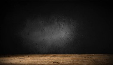 Seçili odak boş kahverengi ahşap masa ve duvar dokusu veya eski siyah tuğla duvar arkaplan bulanık görüntüsü. Fotomontaj ya da ürün gösterimi için