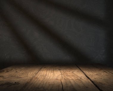 Karanlık oda arka planında bulanık beton duvar olan eski ahşap masa..
