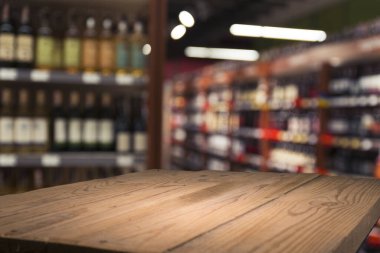 Süpermarket arka planı, bulanık market arkaplanı, ahşap masa, raf ve bulanık kadın süpermarketten alışveriş yapıyor marketin perakende satış için ahşap tezgah, dekor, şablon.