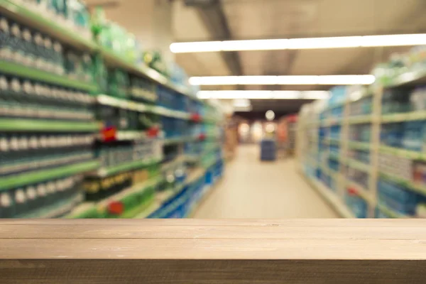 Supermarket background, Counter over blur grocery background, Wooden desk, table, shelf and blur woman shopping at supermarket, Wood counter for grocery store retail product display backdrop, template