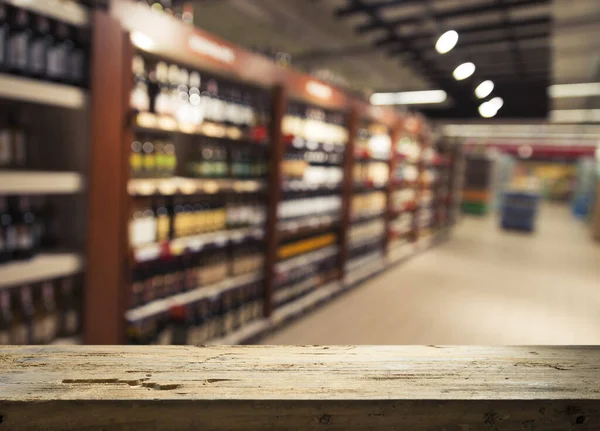 Supermarket background, Counter over blur grocery background, Wooden desk, table, shelf and blur woman shopping at supermarket, Wood counter for grocery store retail product display backdrop, template