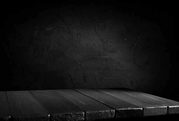 Wooden table with dark blurred background.