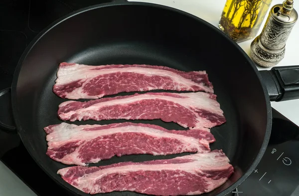 raw meat beef bacon in a pan marbled beef